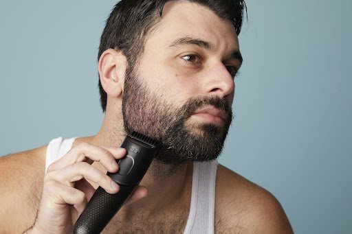 Mastering Facial Hair Grooming: Your Complete Local Guide 1 A man grooming his beards